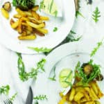 vegan aubergine (eggplant) steak on a plate with chips and vegan Béarnaise